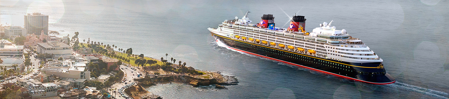 Disney Cruise Line ship sailing alongside the coast of an island